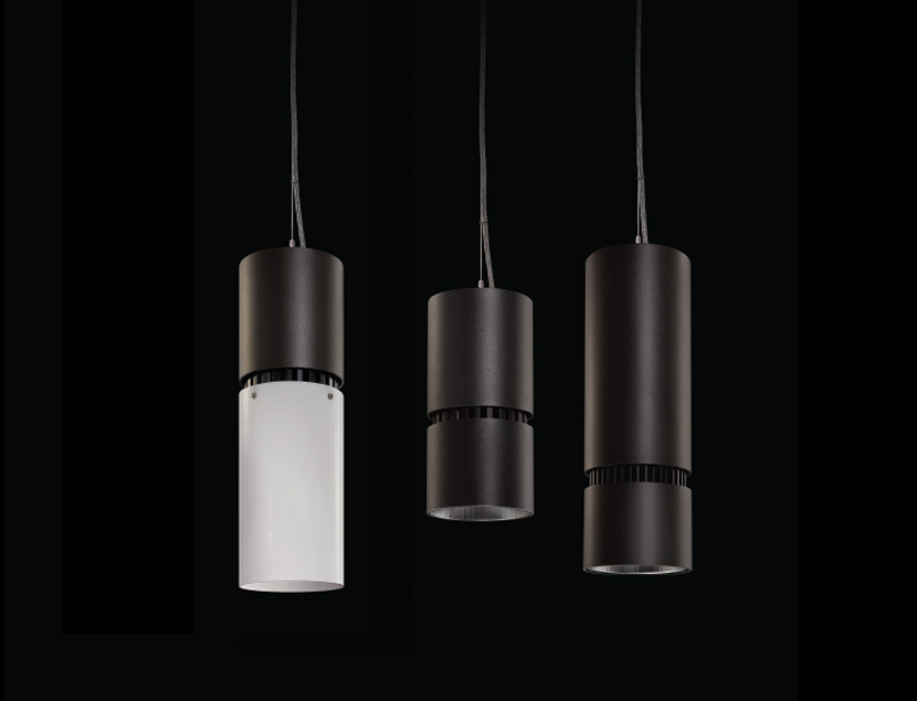 Close up of 3 Aramis fixtures on black background